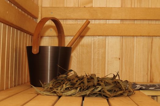 Sauna room. Bucket with a bucket, broom and eucalyptus.