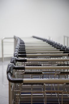 A row of luggage carts at the departure hall in the airport