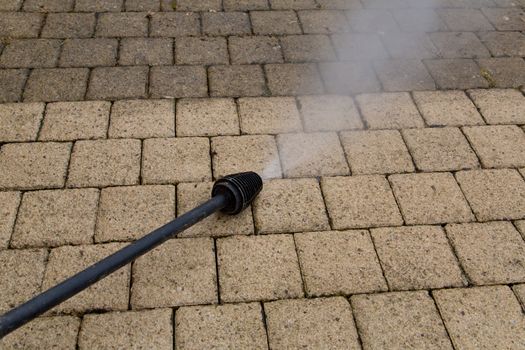 Outdoor floor cleaning with high pressure water jet