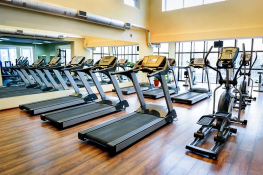 Set of treadmills staying in line in the gym