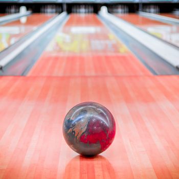 Ball brown with beautiful pattern on bowling alley.