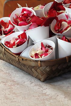 Rose petals in cup for scattering in wedding