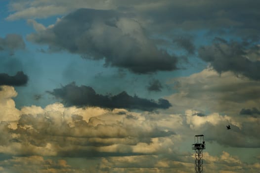 Summer cloudscape with blue sky, dirty smoke and steel tower horizontal