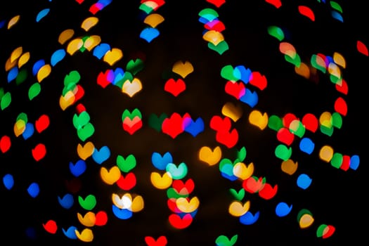 Colorful color lights bokehin the form of hearts, background