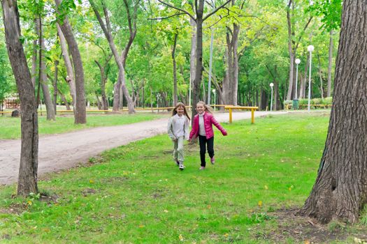 Photo of cute two running girls in summer