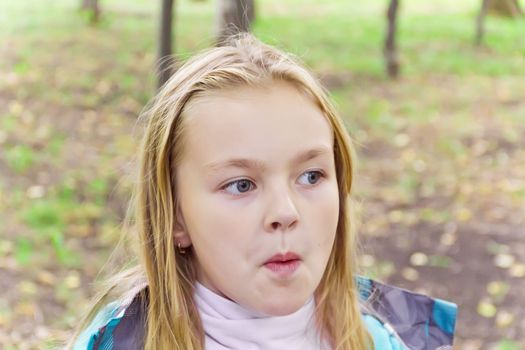 Cute girl with blond long hair and blue eyes