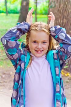 Photo of cute girl with upwards hands
