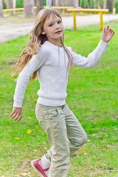 Photo of cute playing girl in summer