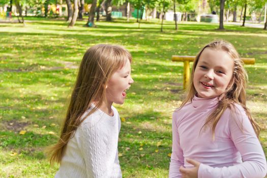 Photo of two playing girls in summer