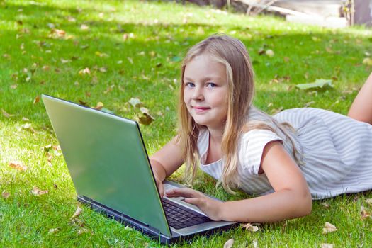 Photo of cute girl with laptop in summer