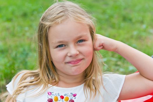 Cute girl with blond long hair and blue eyes