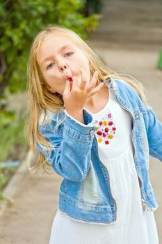 Cute girl with blond long hair in summer