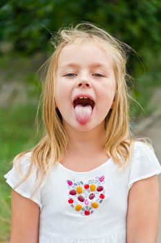 Portrait of cute girl with put out tongue