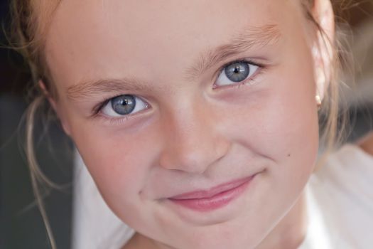 Cute girl with blond long hair and blue eyes