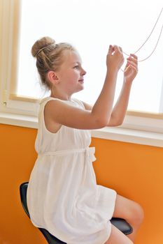Photo of cute playing girl with blond hair