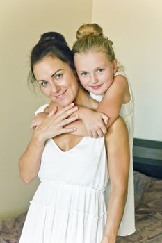 Photo of mother and daughter in white