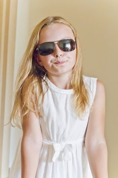 Photo of cute girl playing with sunglasses