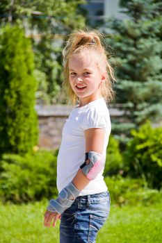 Photo of cute girl on roller skates in summer
