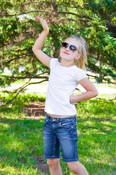Photo of cute dancing girl with sunglass in summer