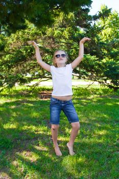 Photo of cute dancing girl with sunglass in summer