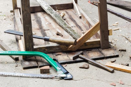 fixed table with carpenter's tools, saw, hammer and knife