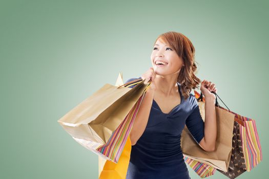 Cheerful shopping woman of Asian holding bags.