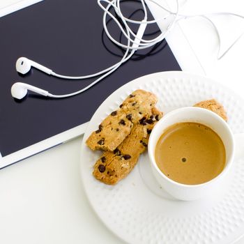 modern business background. Computer tablet with coffee and cookies on white background
