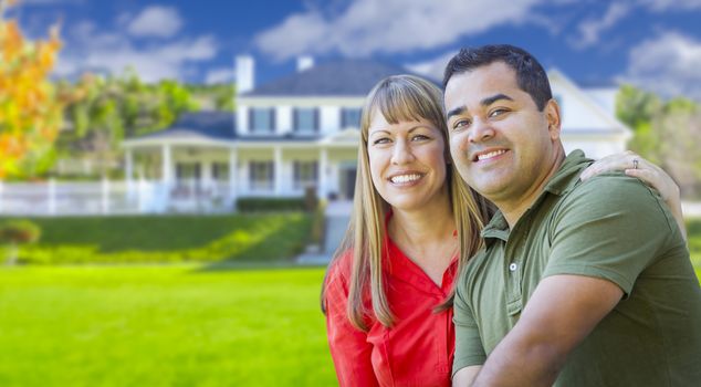 Happy Mixed Race Couple in Front of Beautiful House.