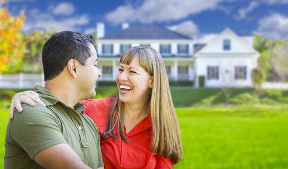 Happy Mixed Race Couple in Front of Beautiful House.