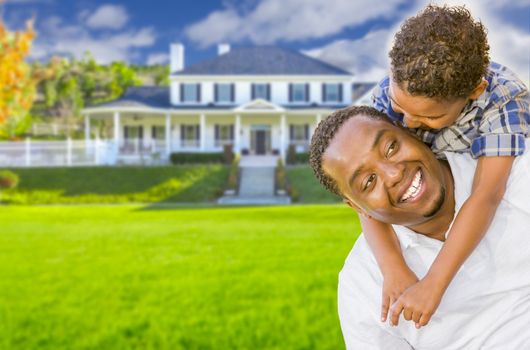 Happy Playful African American Father and Mixed Race Son In Front of House.