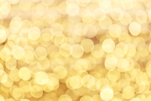Yellow defocused glitter background with copy space