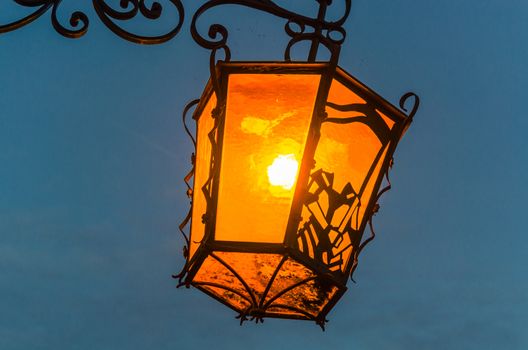 Old Antique Road lantern lit against the night sky