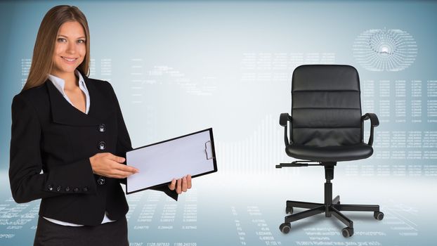 Businesswoman smiling showing blank clipboard. Hi-tech graphs with various data as backdrop