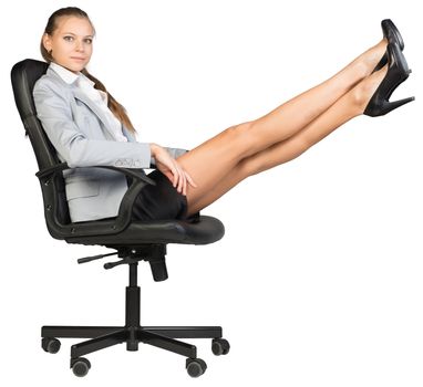 Businesswoman on office chair, looking at camera, with her feet up on anything. Isolated over white background