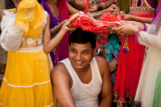 Indian groom doing marriage rituals with cross their mandap puja