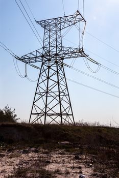 Electricity pylon on the ground with dry grass