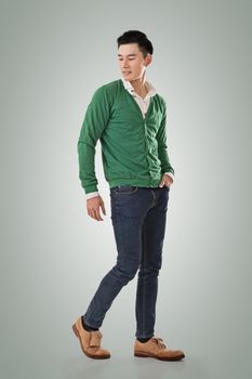 Handsome young Asian man with sweater, full length portrait isolated.