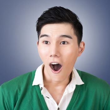 Funny facial expression, closeup Asian young man.