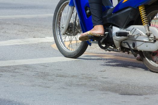 motorcycle stop at white line on junction waiting for traffic light in Thailand