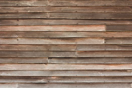 Perfectly lit wooden background with weathered wood and rusty nails