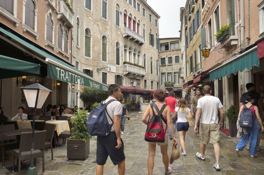 Tourists walking by a street in the city of Venice, Italy