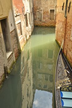 Building Reflection on water of a narrow canal in Venice, Italy.