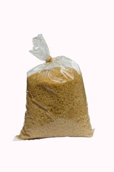 brown granulated sugar in plastic bag for selling isolated in white background