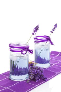 Fresh organic lavender lemonade with fresh lavender blossom isolated on white background. Healthy fresh nonalcoholic summer drink. 