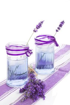 Lavender lemonade with fresh lavender blossom isolated on white background. Healthy fresh nonalcoholic summer drink. 