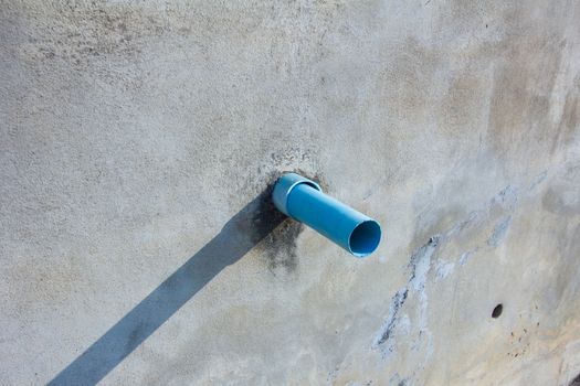 waste pipe on a wall in sunshine