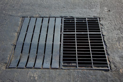 Drain grating on road in Thailand