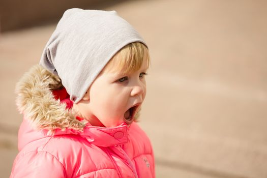 attractive little girl on outdoor playground equipment