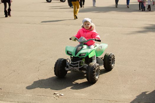 attractive little girl on outdoor playground equipment