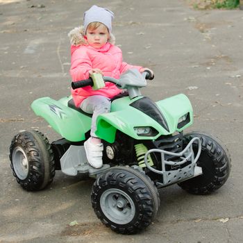 attractive little girl on outdoor playground equipment